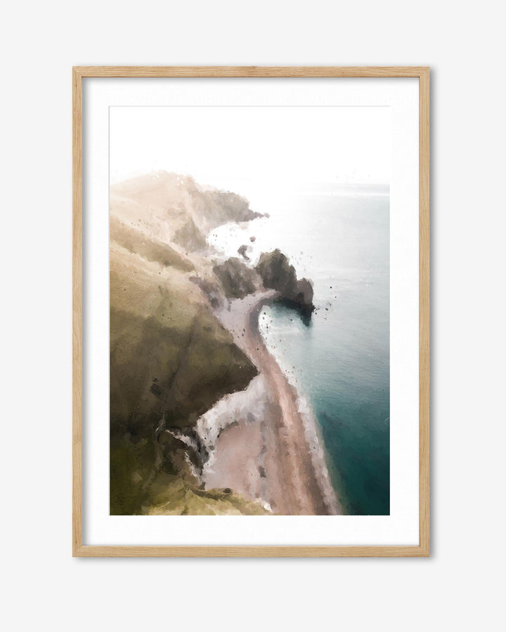 Framed artwork of a coastal landscape with cliffs and ocean.