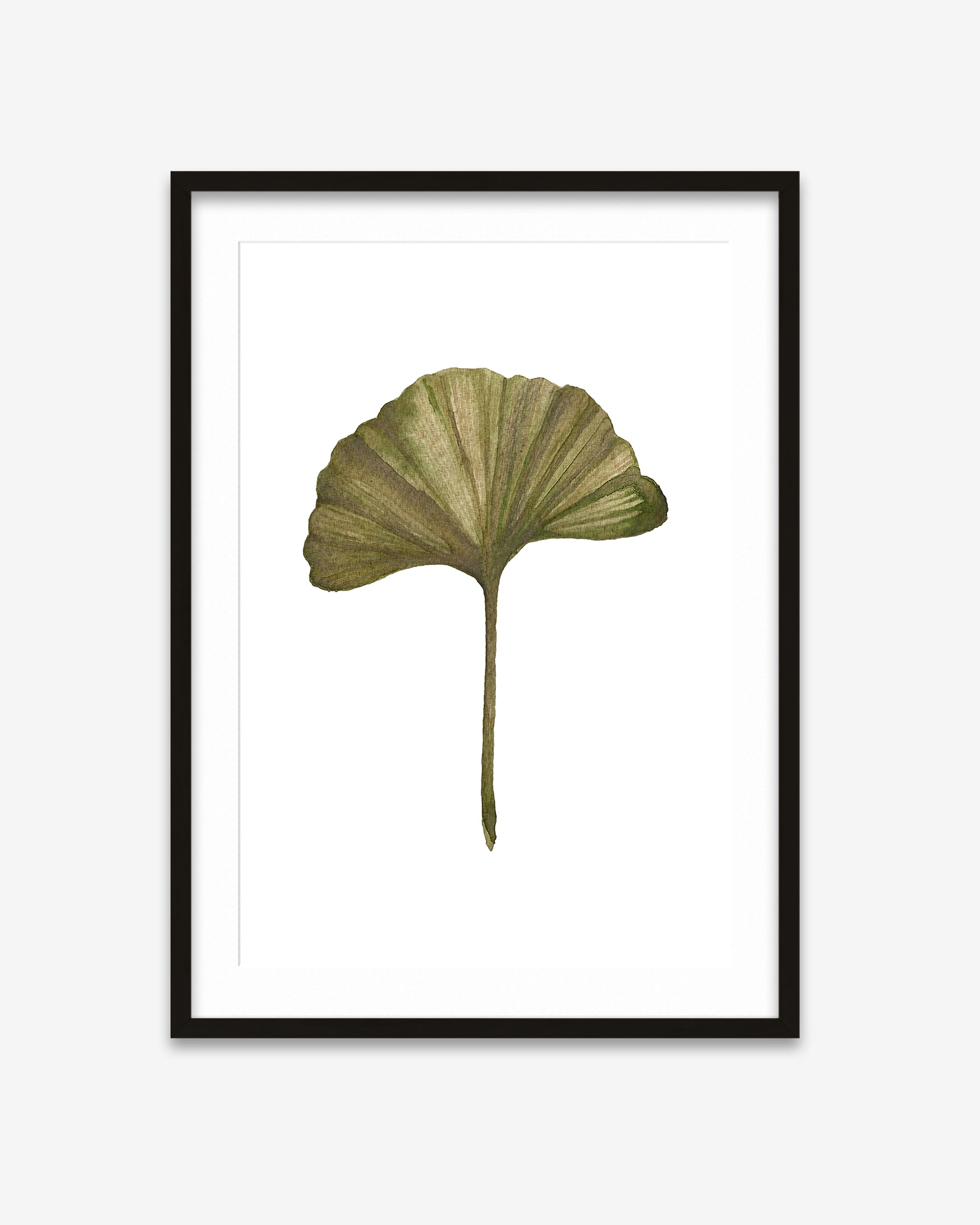 Framed artwork of a green leaf on a white background