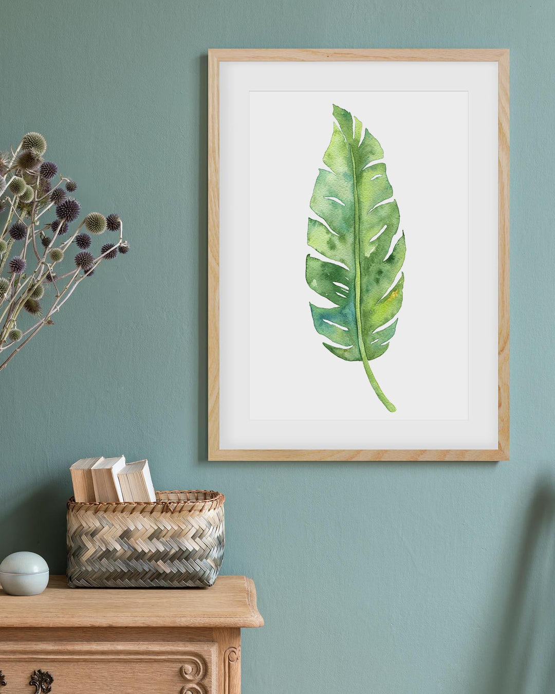 framed botanical art print on a teal wall