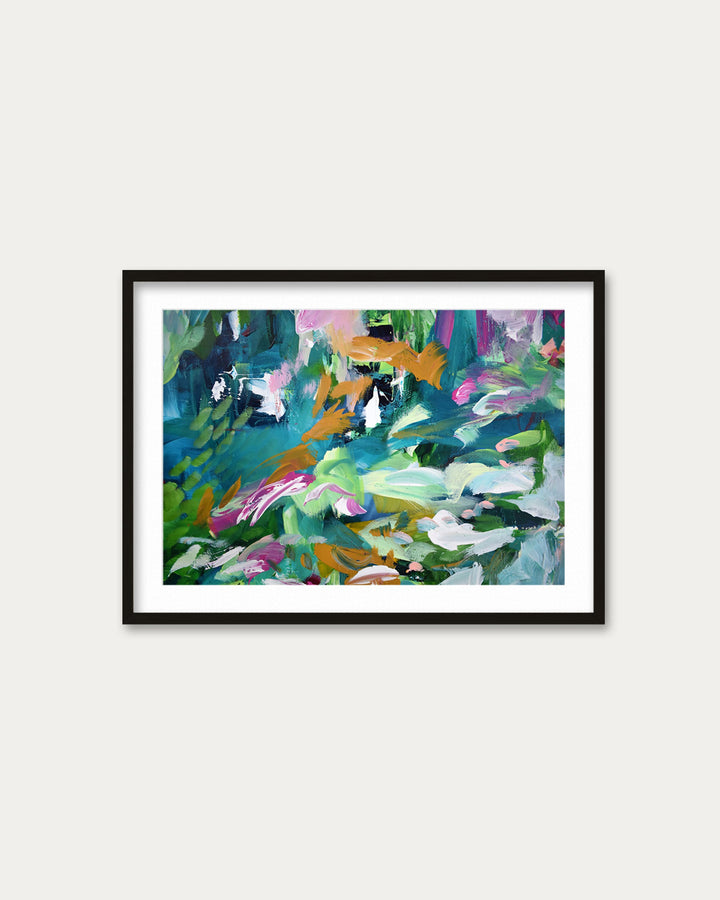 Framed abstract painting with colorful abstract design on a white wall