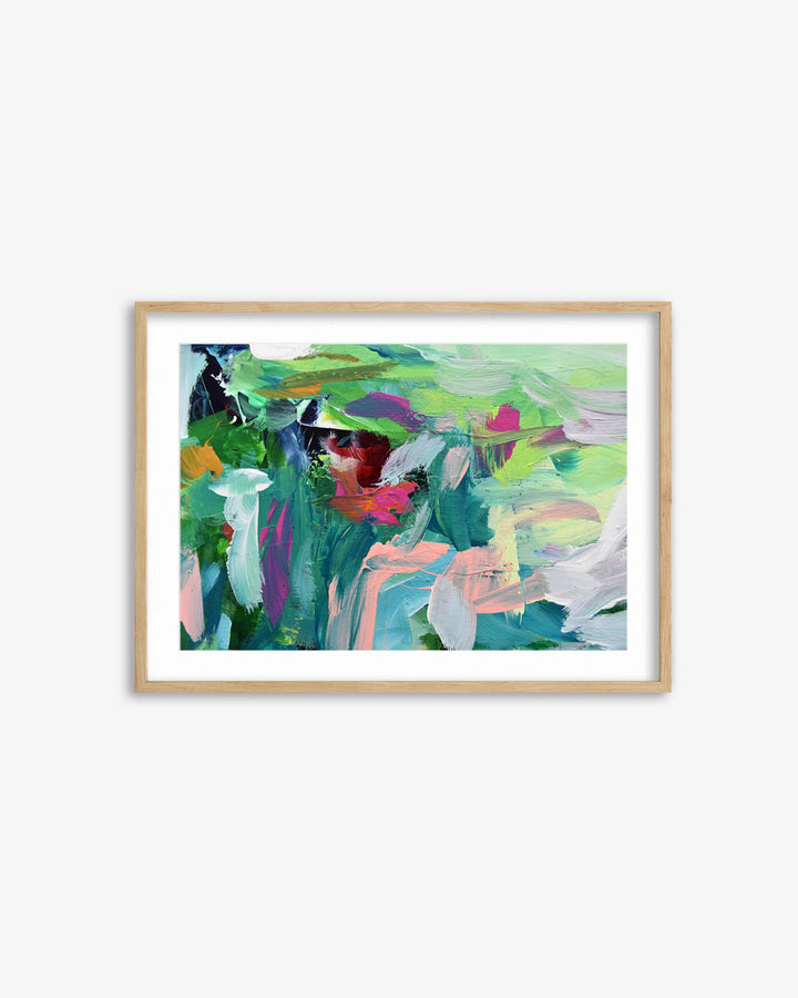 Framed abstract painting with colorful brush strokes on a white wall