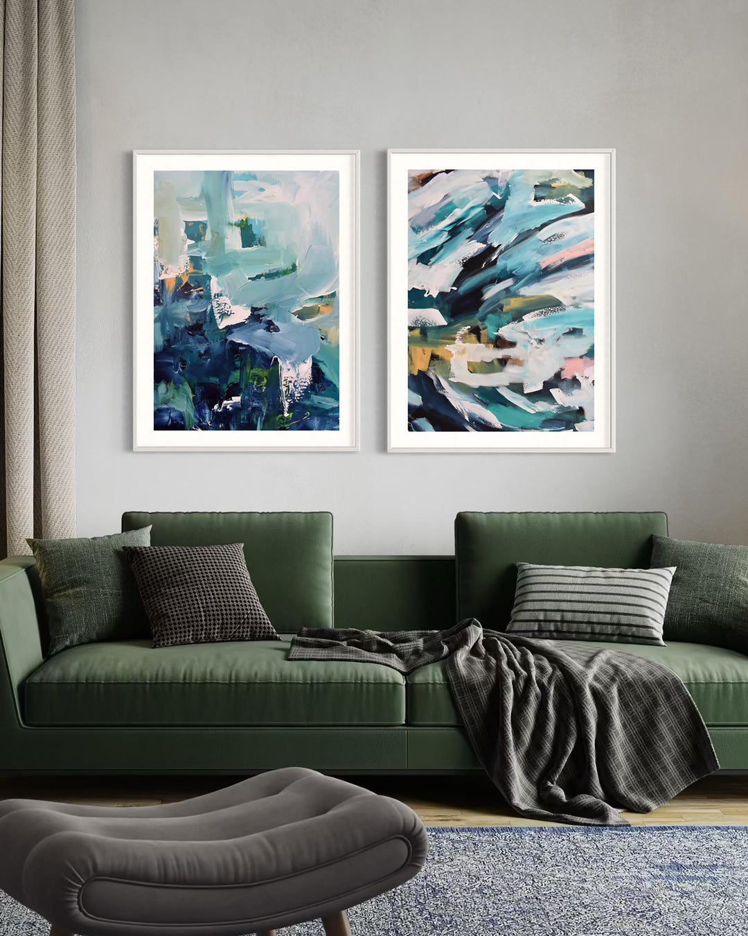 Two abstract paintings on a wall above a green sofa with decorative pillows and a blanket.