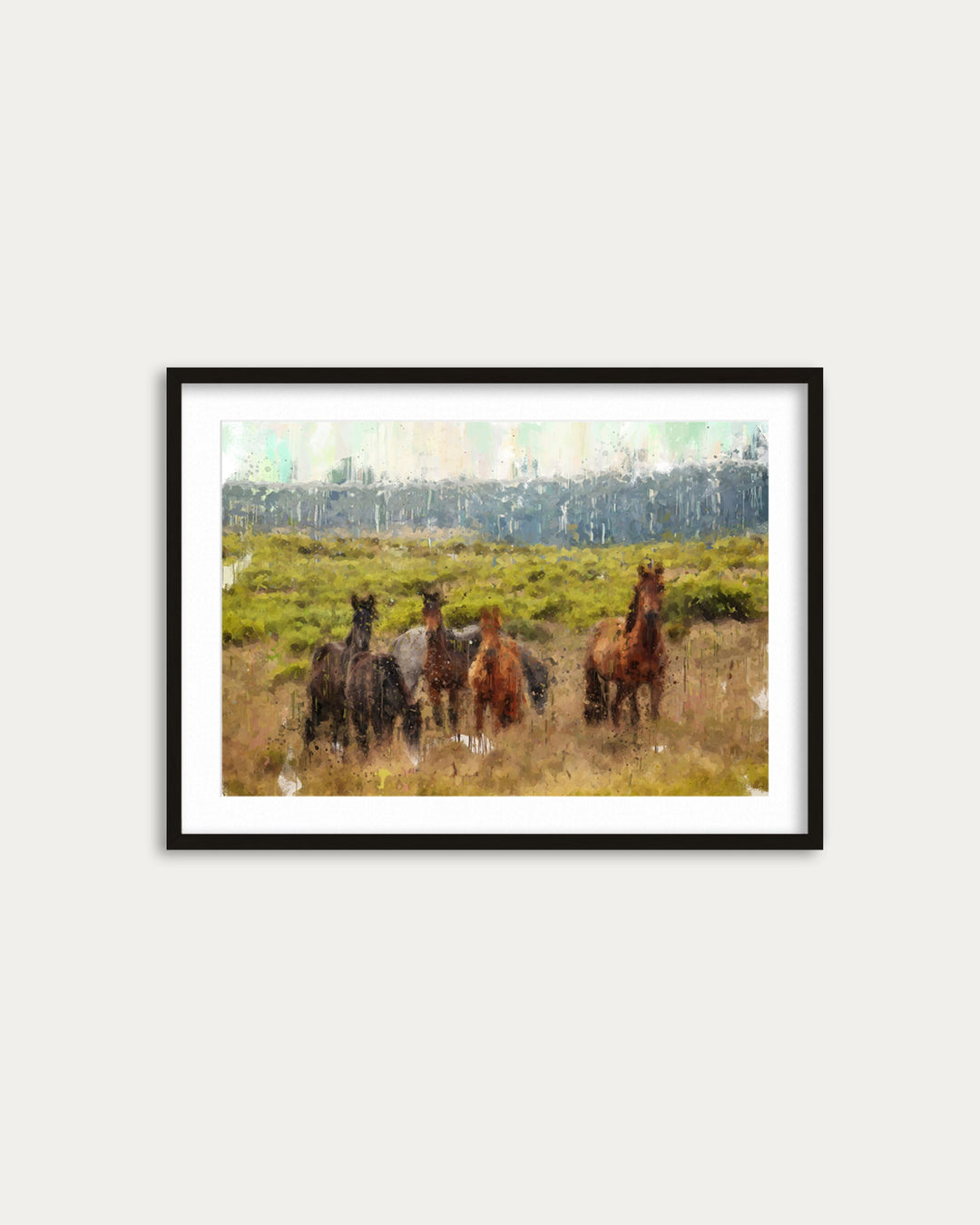 Framed artwork of horses in a field on a white wall
