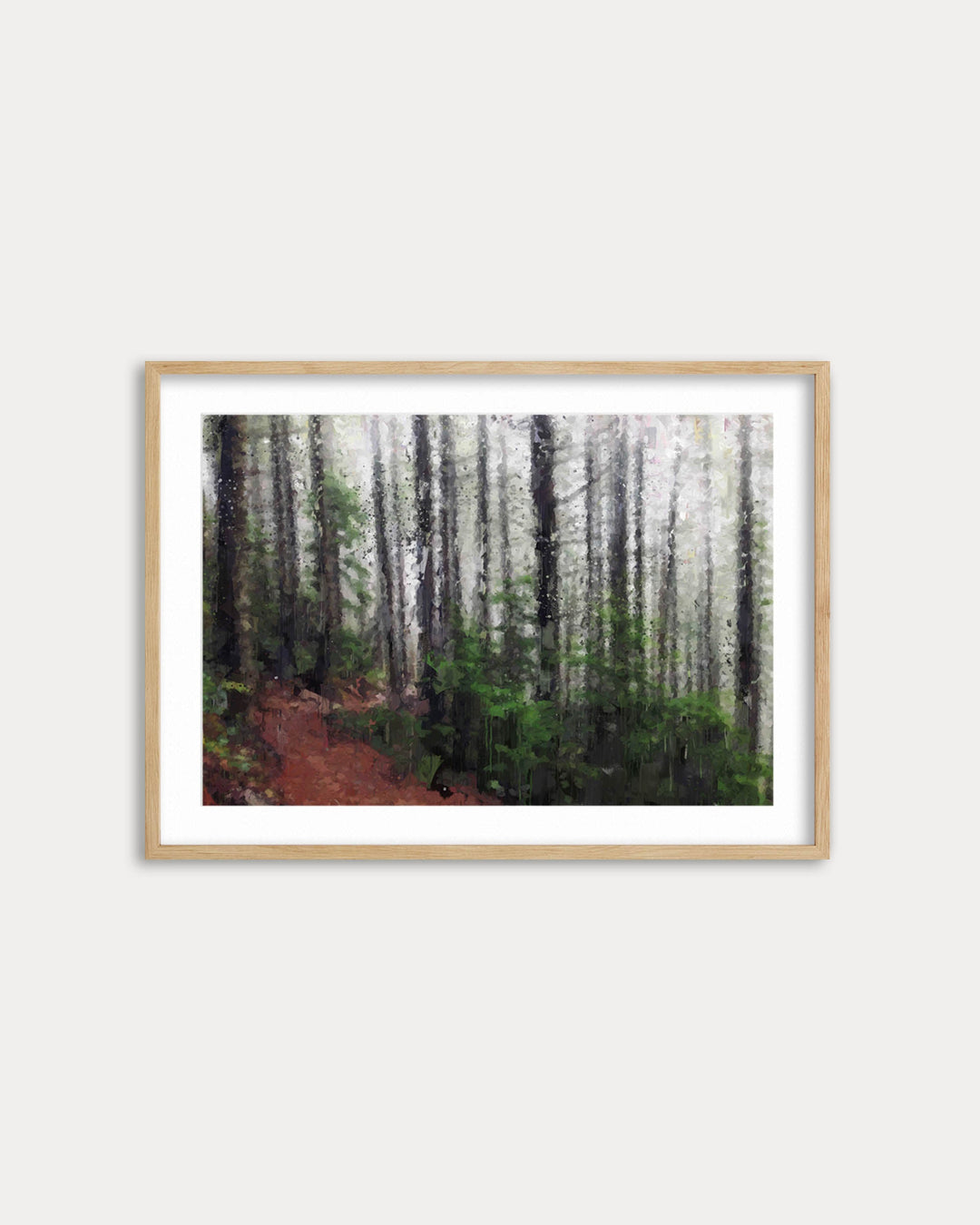 Framed artwork of a forest path on a white wall