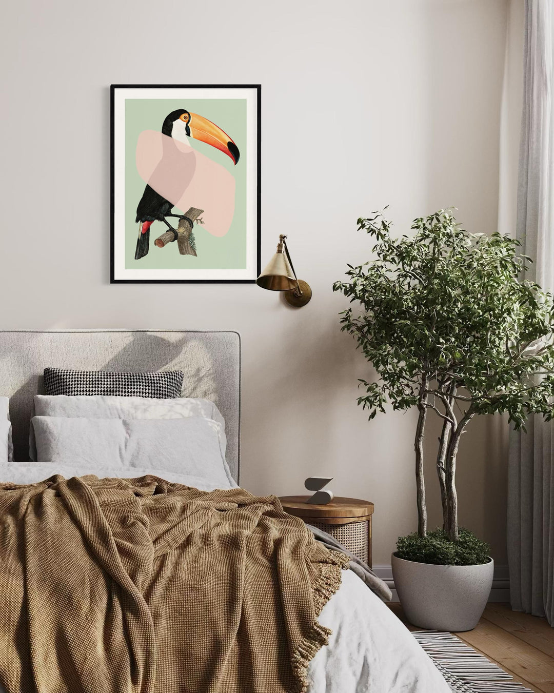 Bedroom with a toucan print on the wall, plant, and cozy bedding.