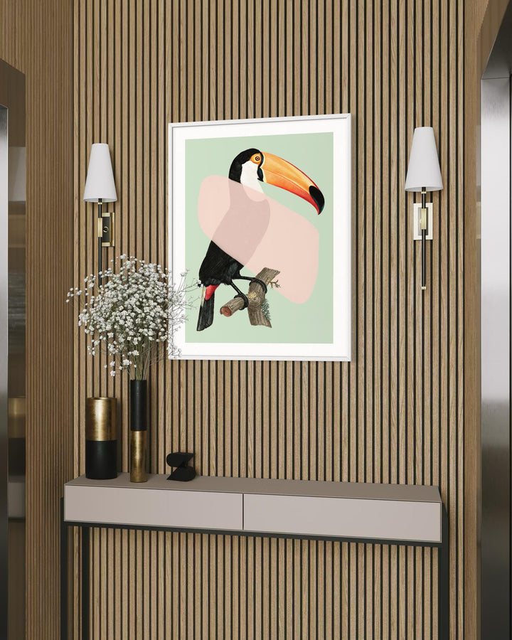 Framed artwork of a toucan on a wall with striped wallpaper and decorative elements.