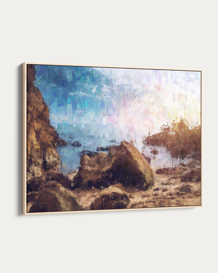 Framed artwork of a coastal scene with rocks and water.