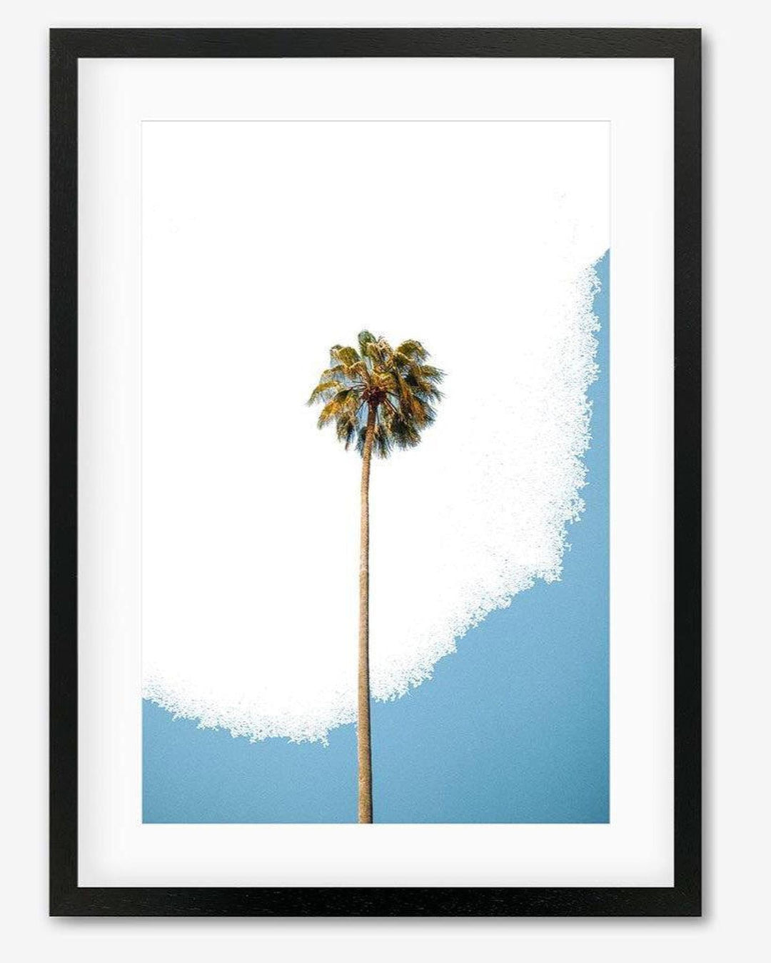A contemporary art print featuring a single palm tree with a blue sky background, mounted on a black frame.
