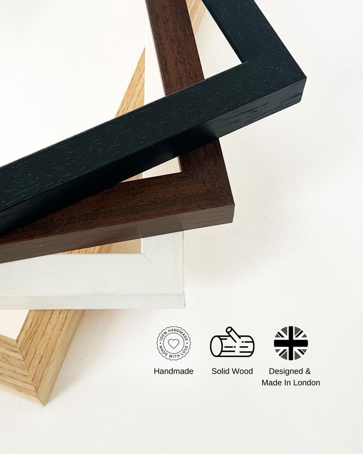 Close-up of wooden picture frames with 'Handmade', 'Solid Wood', and 'Designed & Made In London' labels.