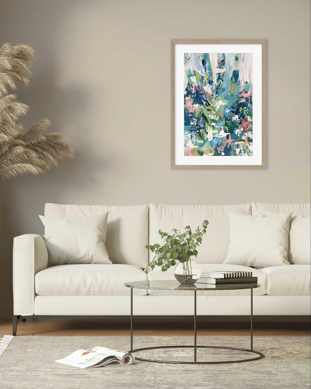 Living room with a white sofa, coffee table, and abstract art on the wall.