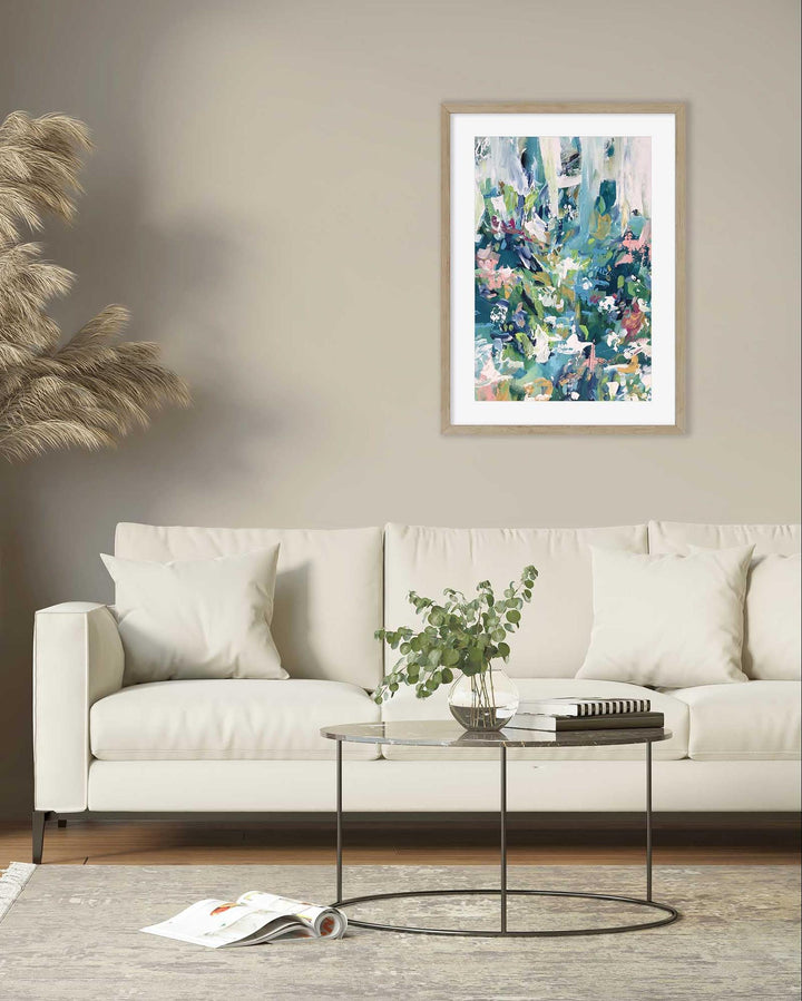 Living room with a white sofa, coffee table, and abstract art on the wall.