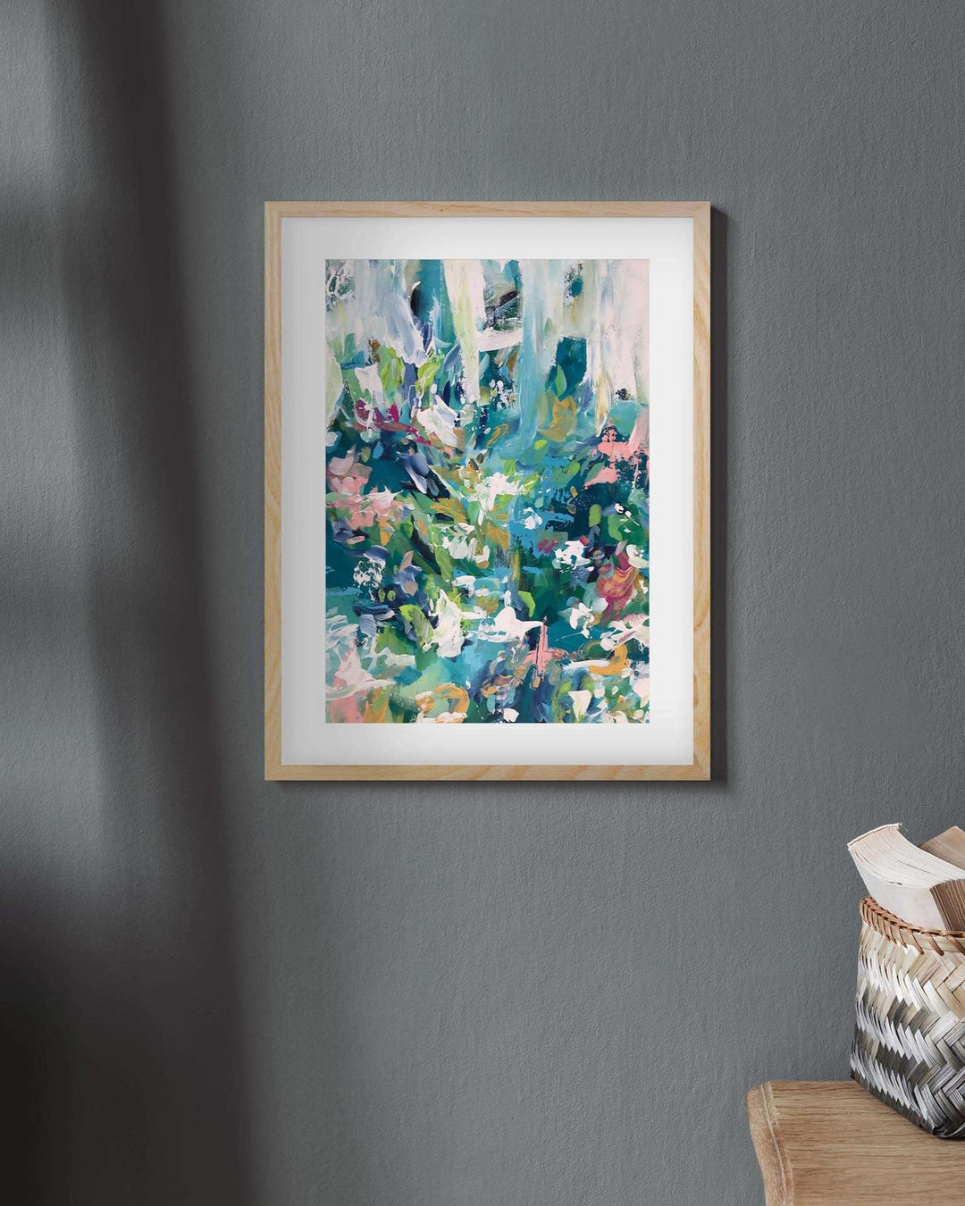 Framed abstract art print colourful in an oak frame on a wall
