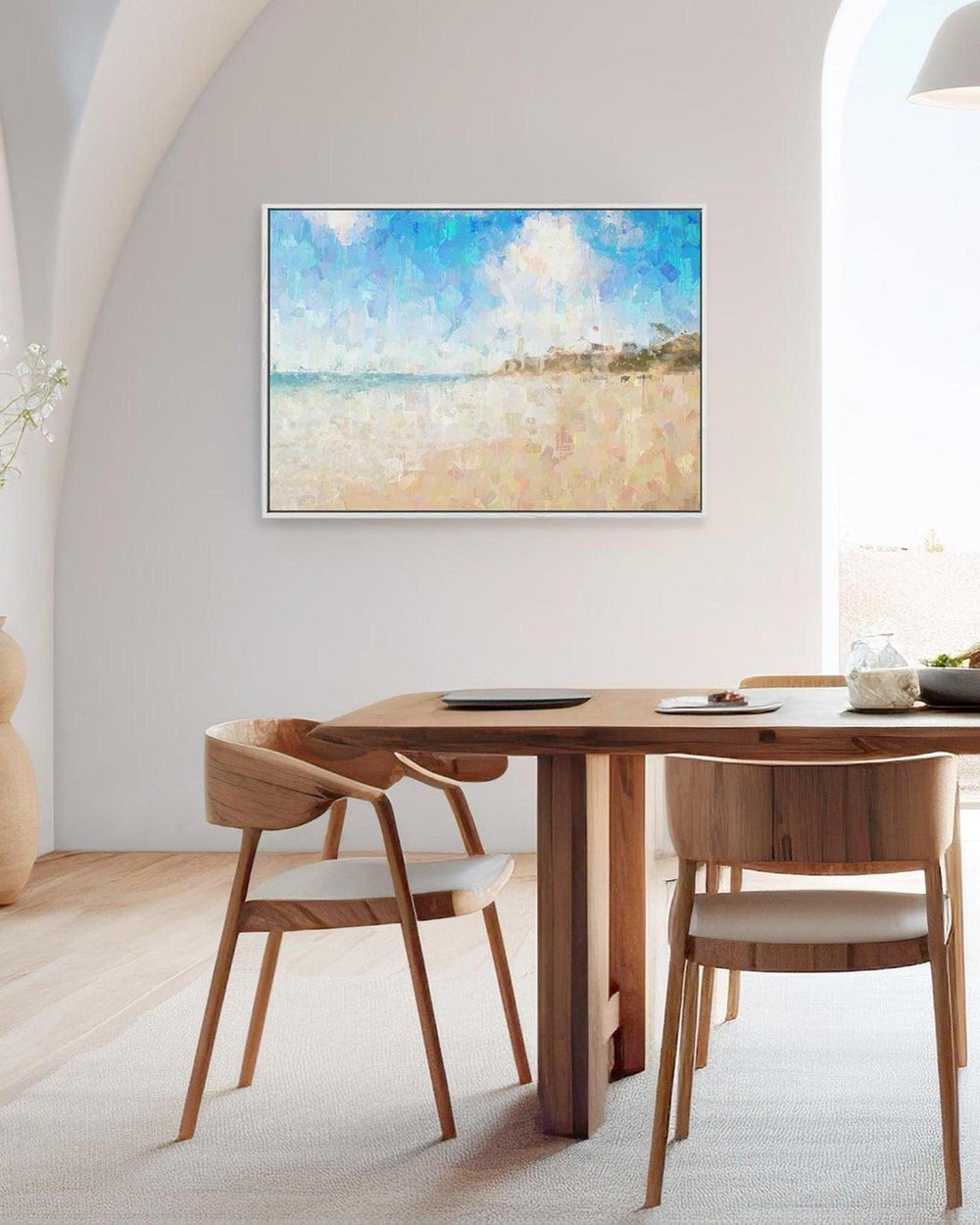 Modern dining room with wooden table and chairs, large TV on the wall, and decorative elements.
