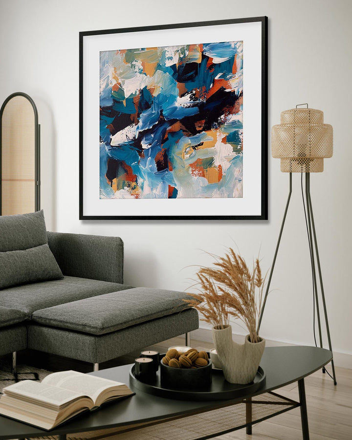Living room with a gray sectional sofa, coffee table, and abstract art on the wall.