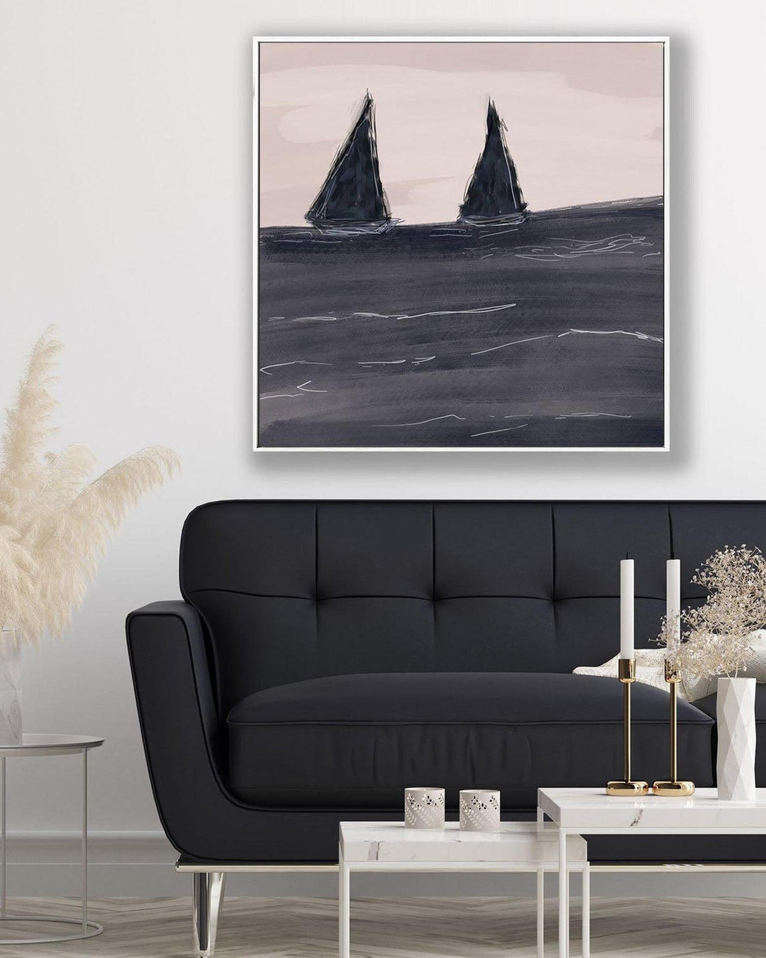Sailing boat painting above a black sofa in a living room