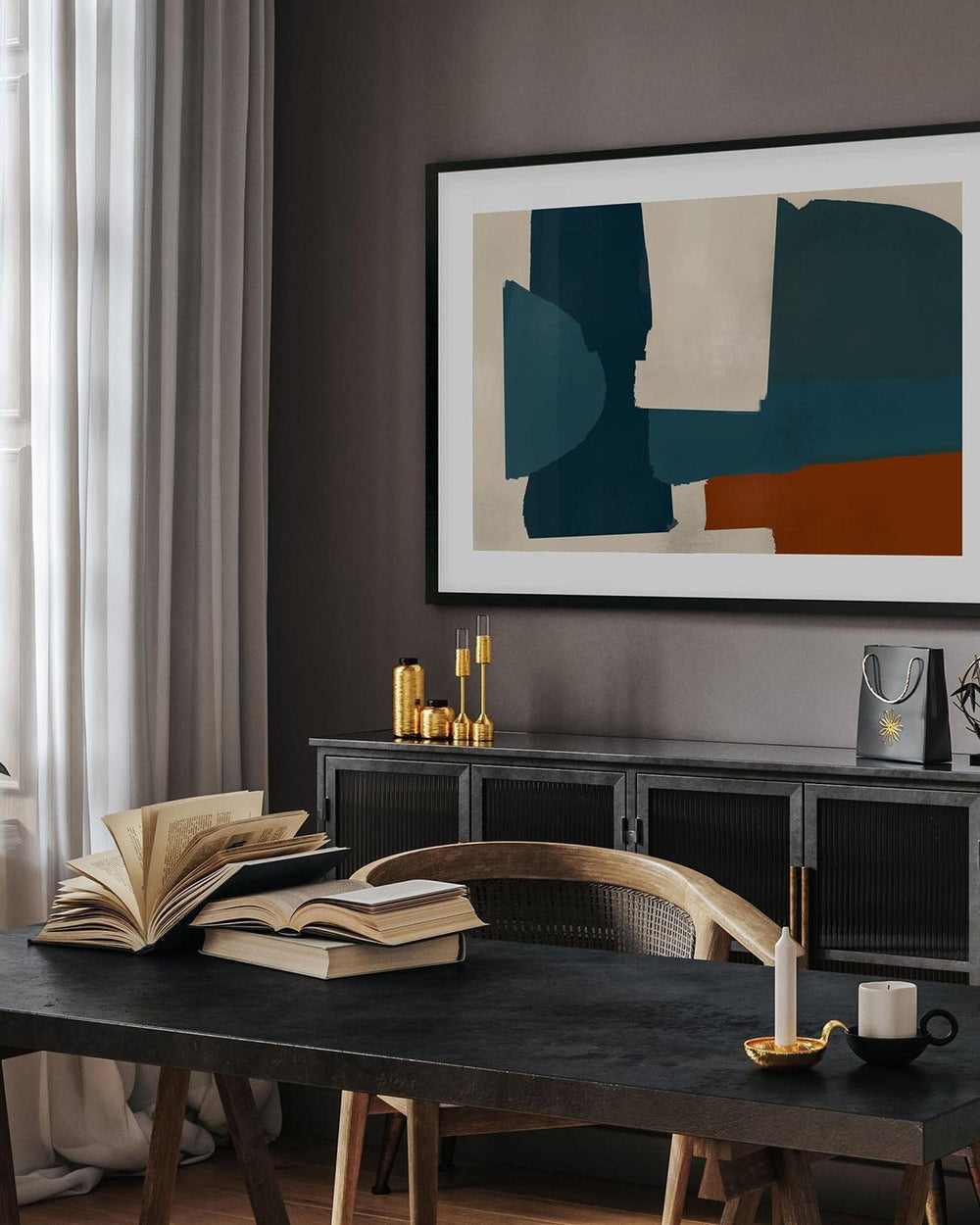 Modern interior with abstract art, books, and a coffee table.