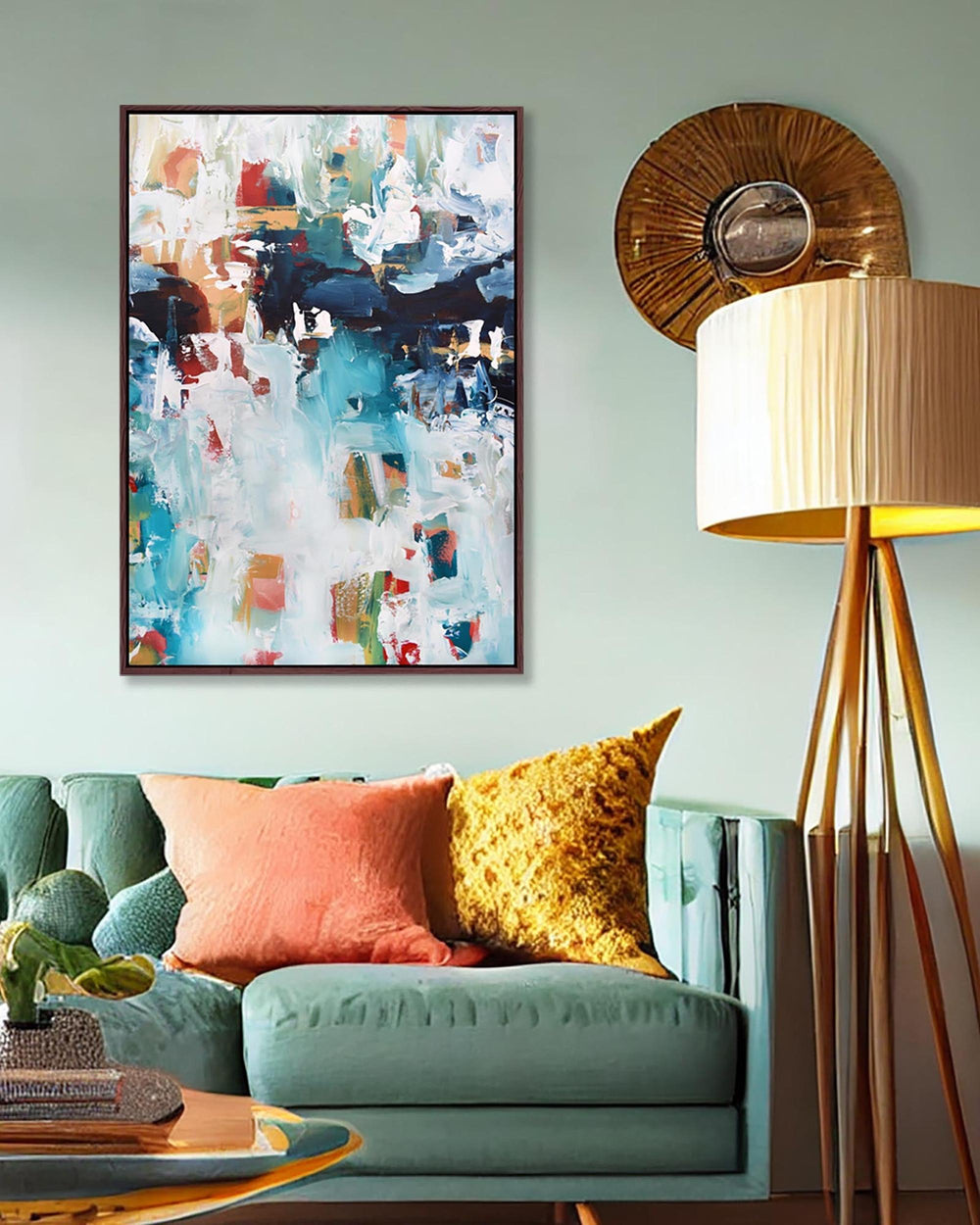 Living room with a teal sofa, colorful pillows, and abstract art on the wall.