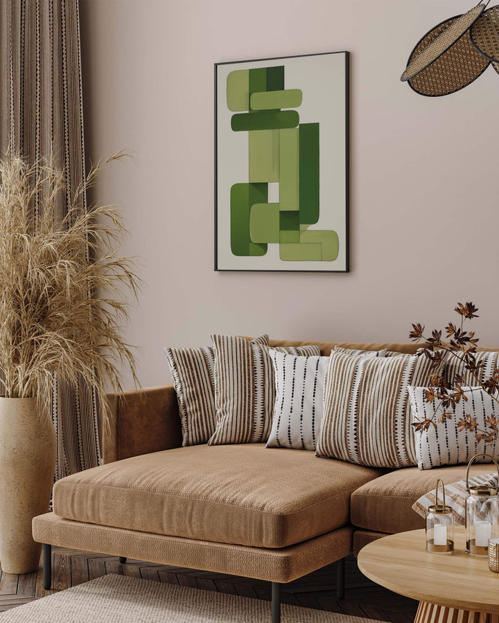 Modern living room with brown neutral sofa and neutral cushions with large green and white geometric abstract wall art poster framed picture on wall