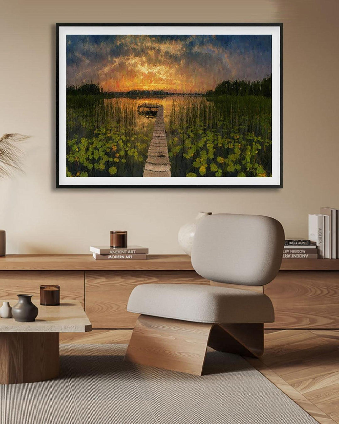 Framed artwork of a sunset over water with a dock, displayed in a modern living room.