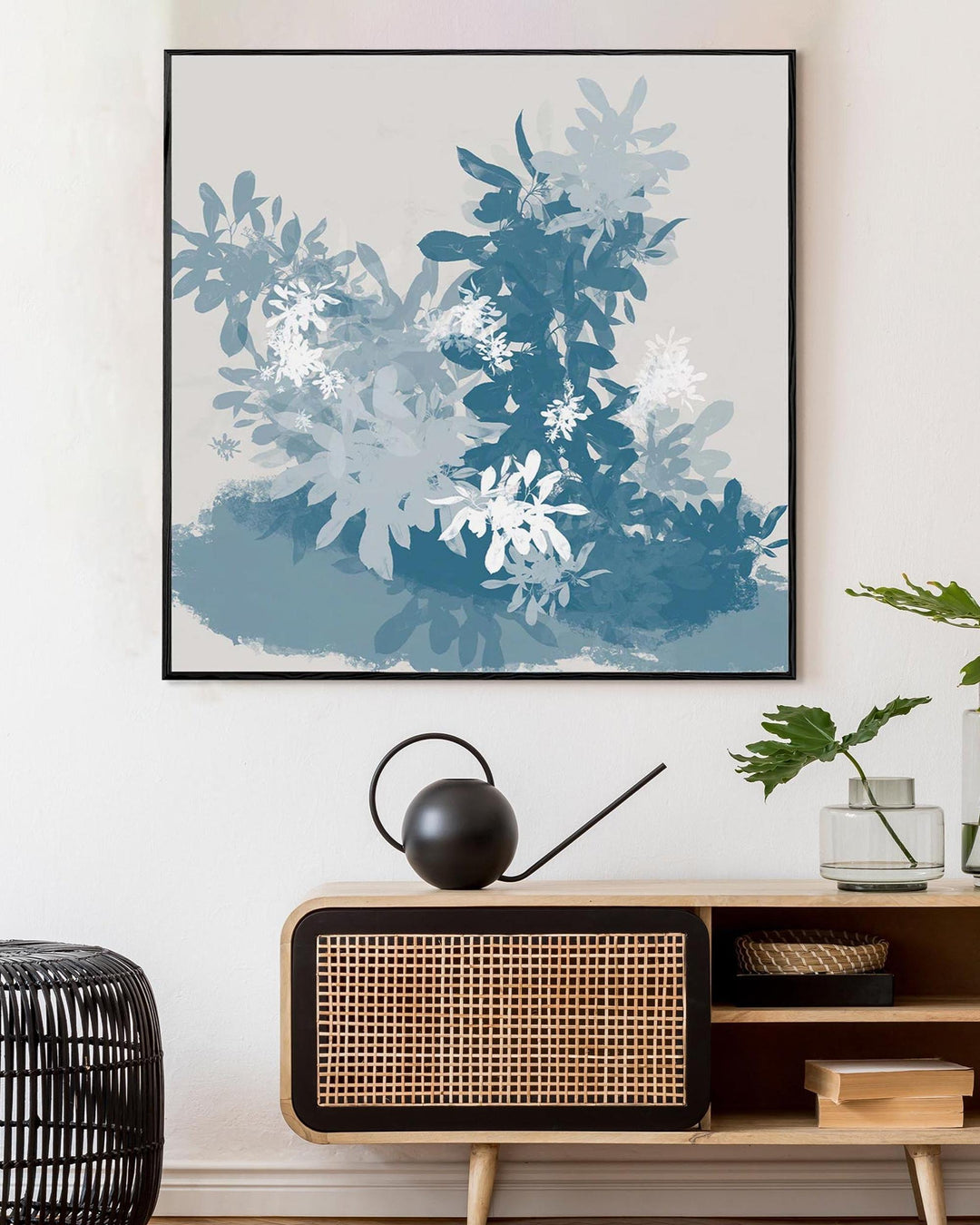 Framed abstract art above a wooden console table with decorative items.