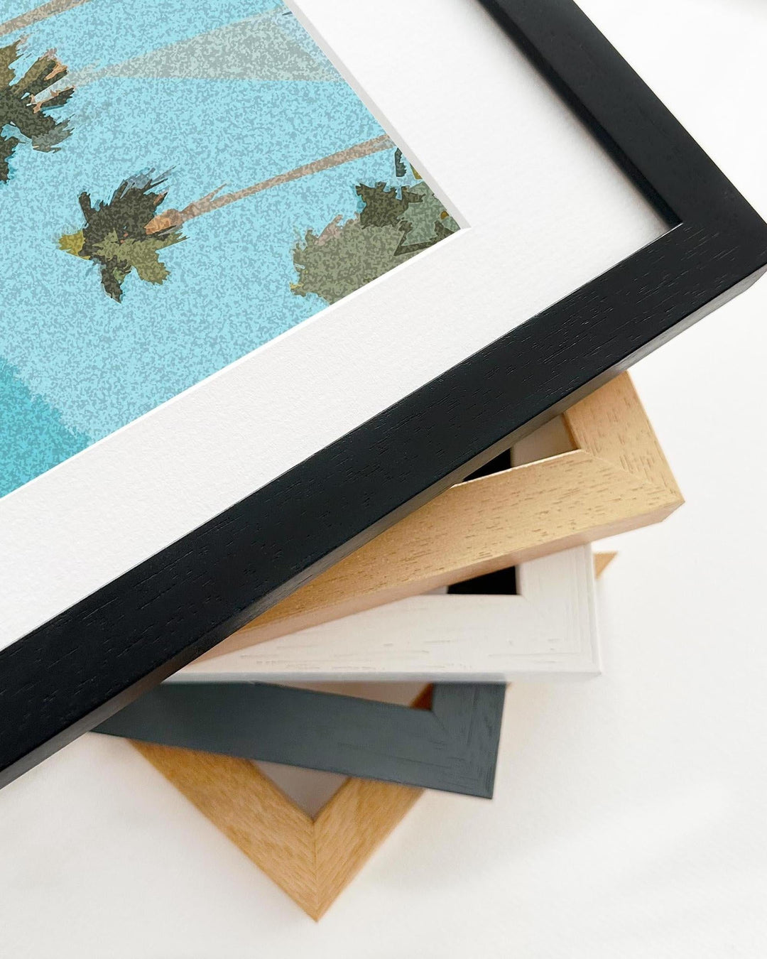 Stack of variously colored picture frames on a white surface