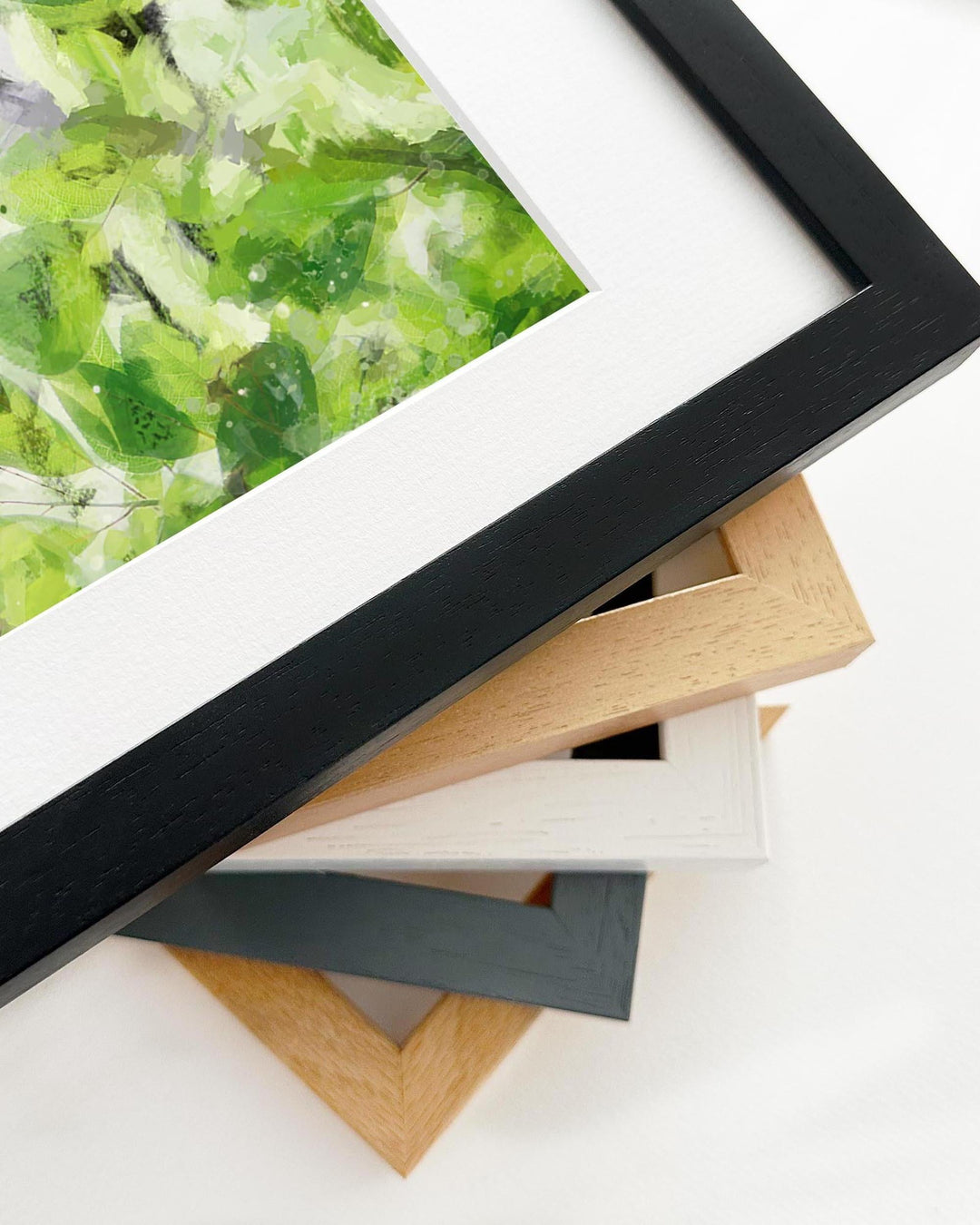Close-up of a framed picture with various frame options on a white background