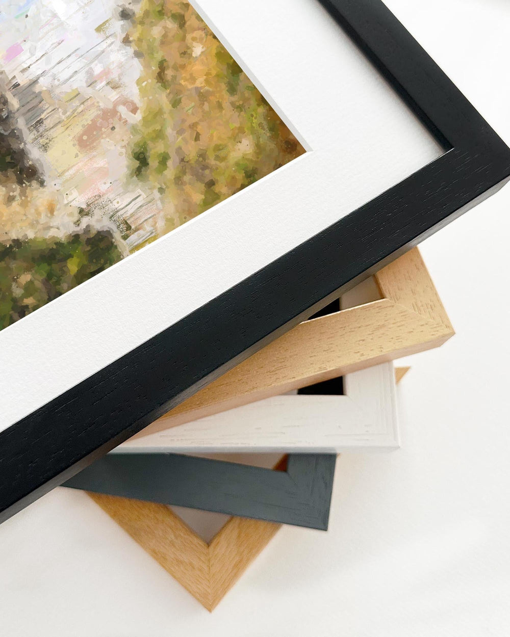 Stack of various picture frames on a white surface