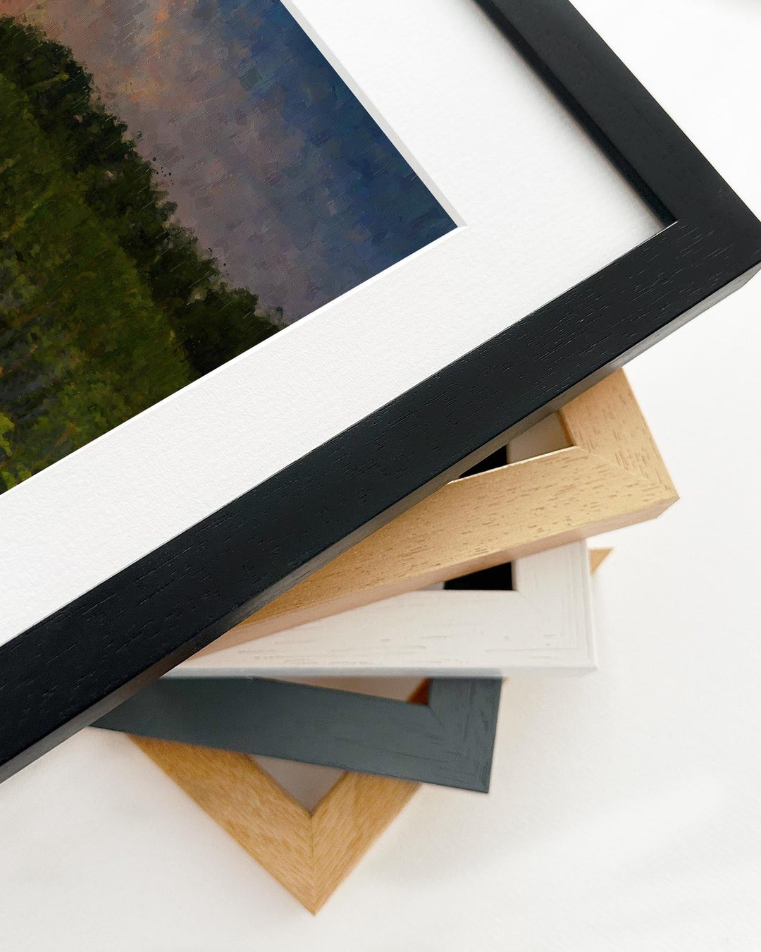 Stack of variously colored picture frames on a white background