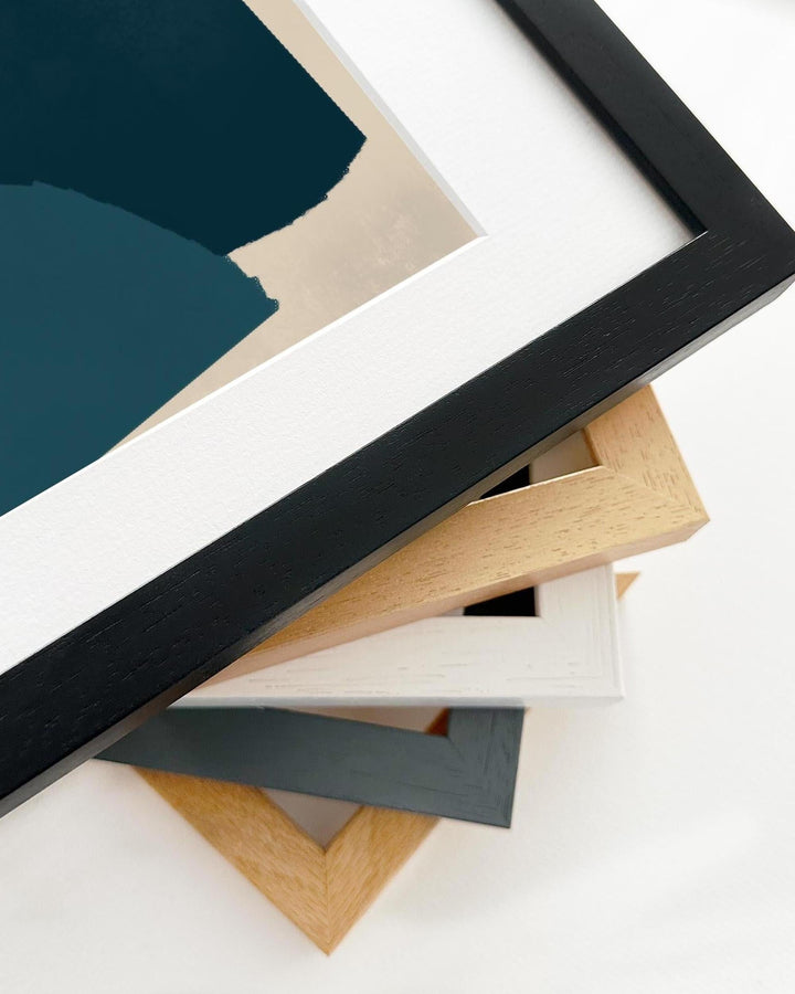 Collection of various wooden picture frames on a white background