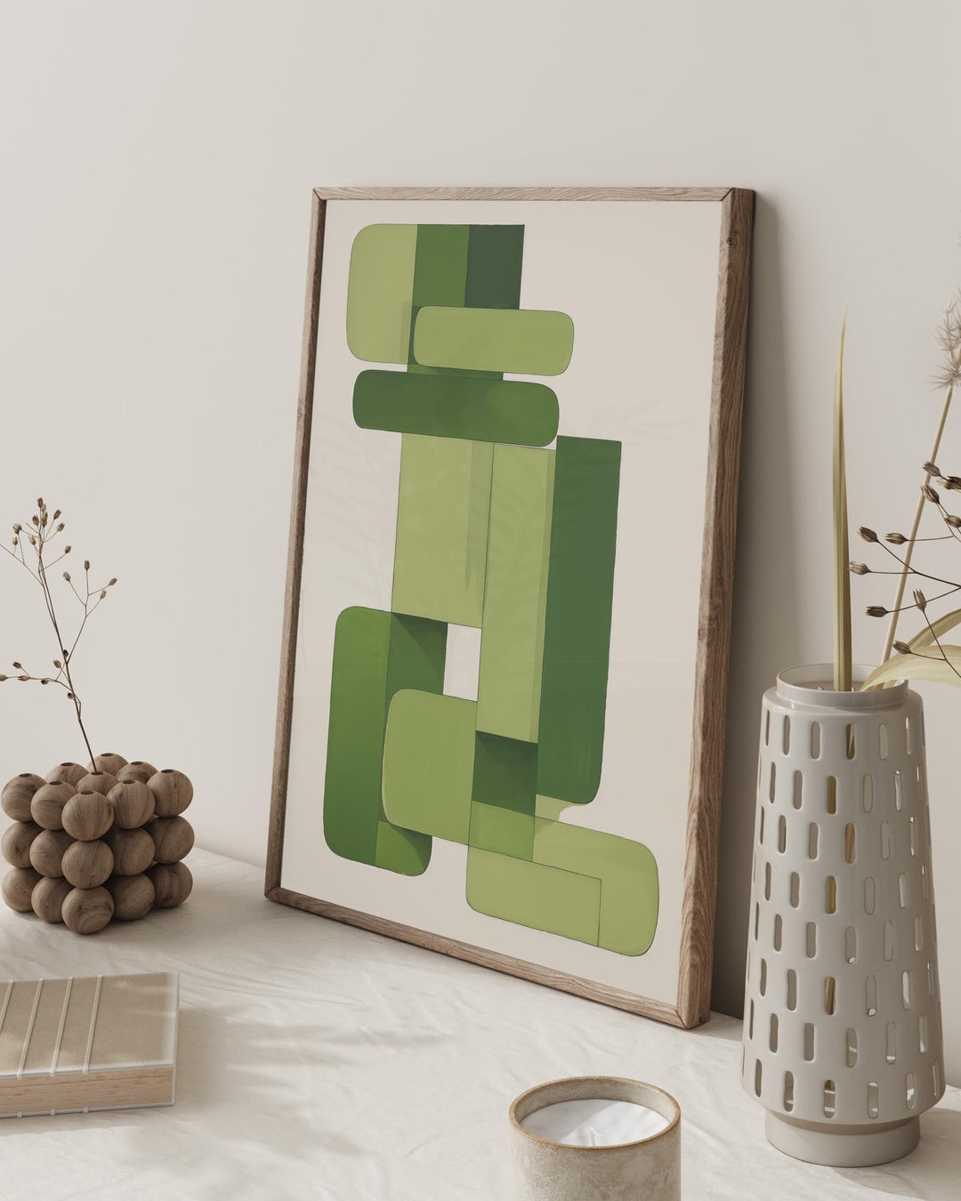 Framed abstract art with geometric shapes on a wall, surrounded by decorative items.