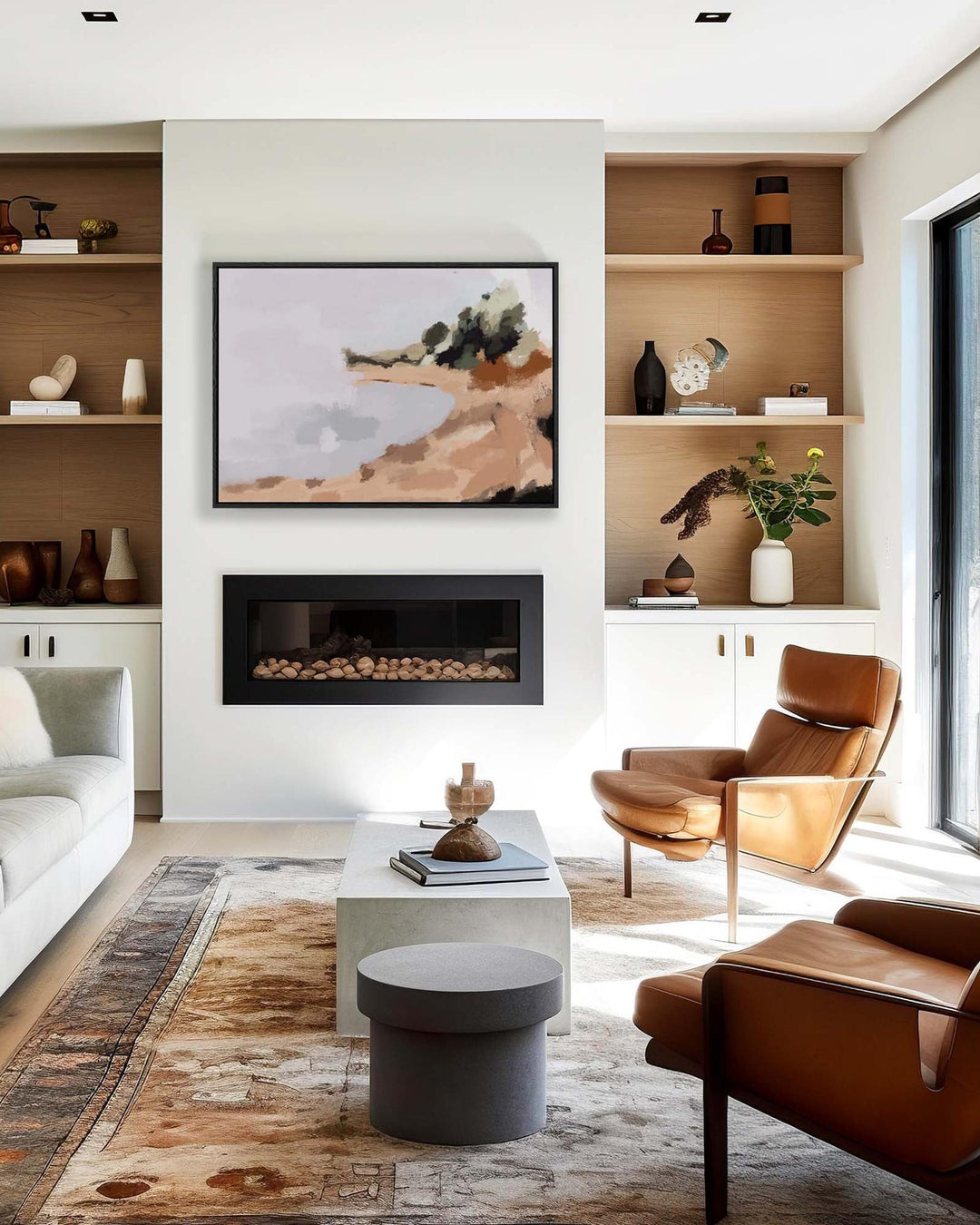 Modern living room with brown chairs, white sofa, and abstract painting above a fireplace.