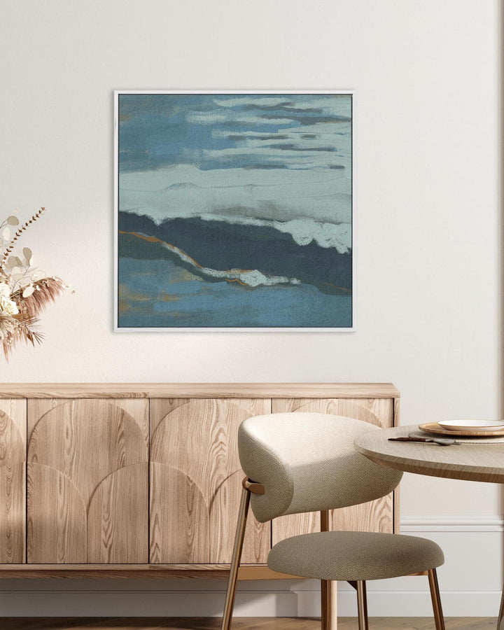Dining room with wooden sideboard, round table, and abstract painting on wall