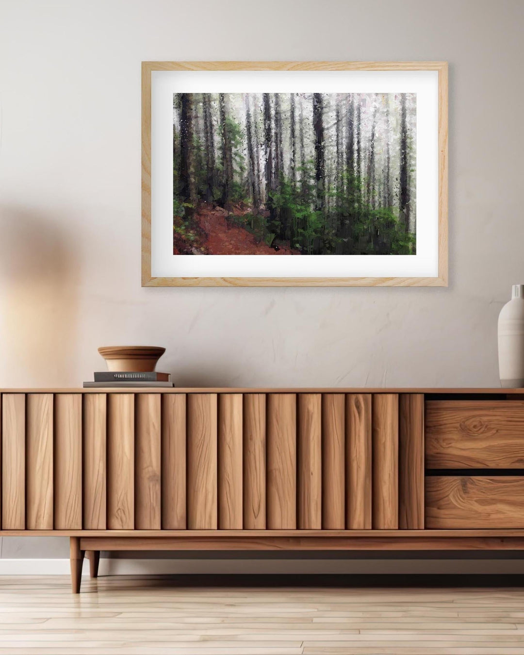 a framed wall art print on a wall above a sideboard 