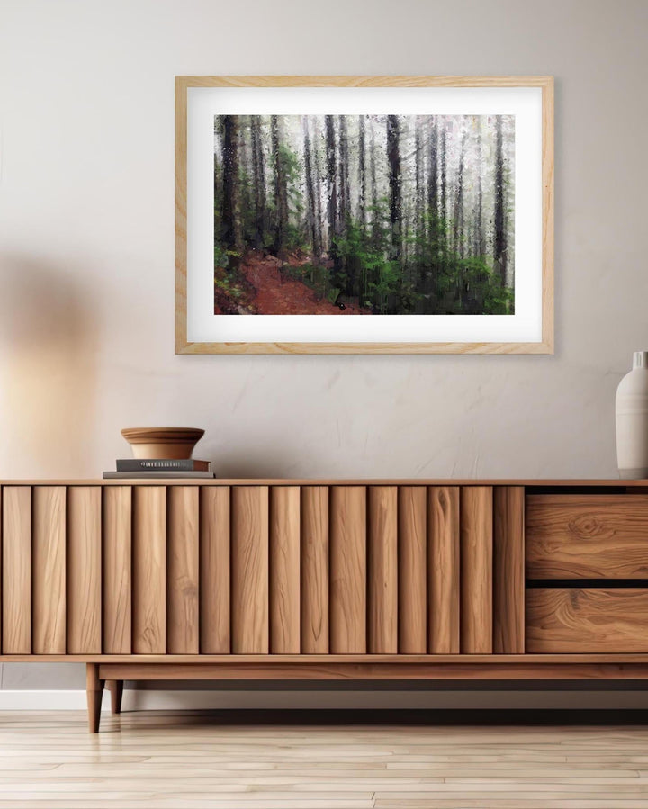 a framed wall art print on a wall above a sideboard 