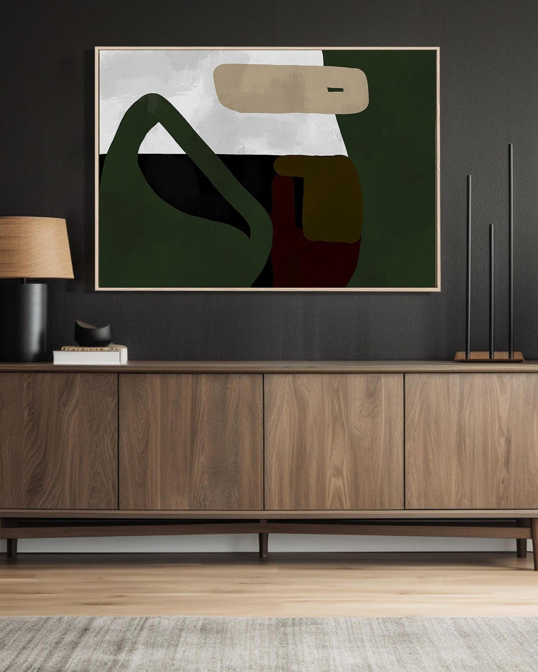 Abstract painting on a wall above a wooden cabinet in a room.