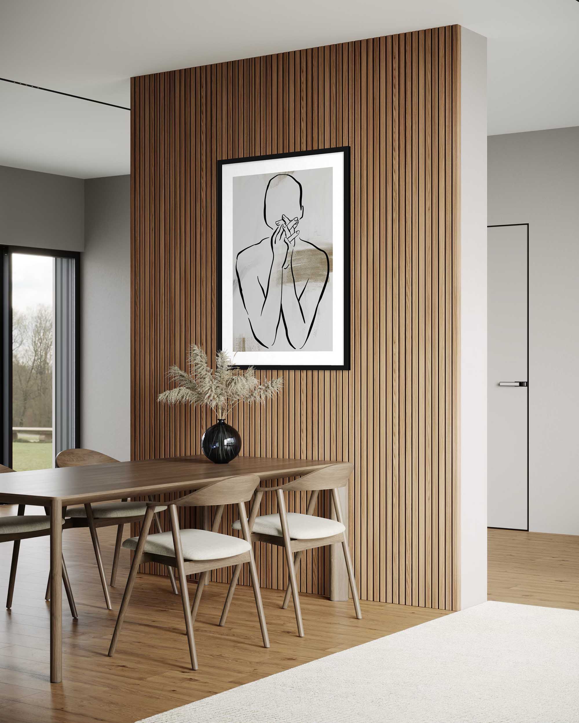 Dining room with wooden table and chairs, framed artwork on a wooden wall.