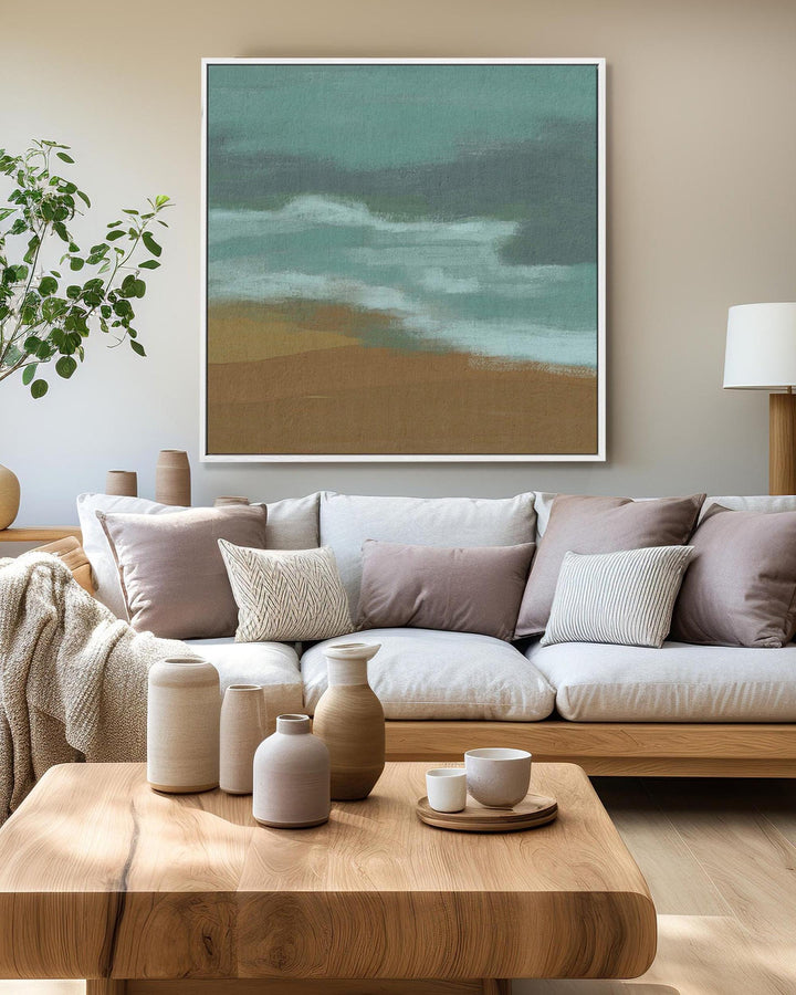 Modern living room with a sofa, coffee table, and decorative items.