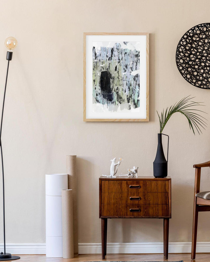 Modern interior with abstract art, wooden side table, and decorative items.