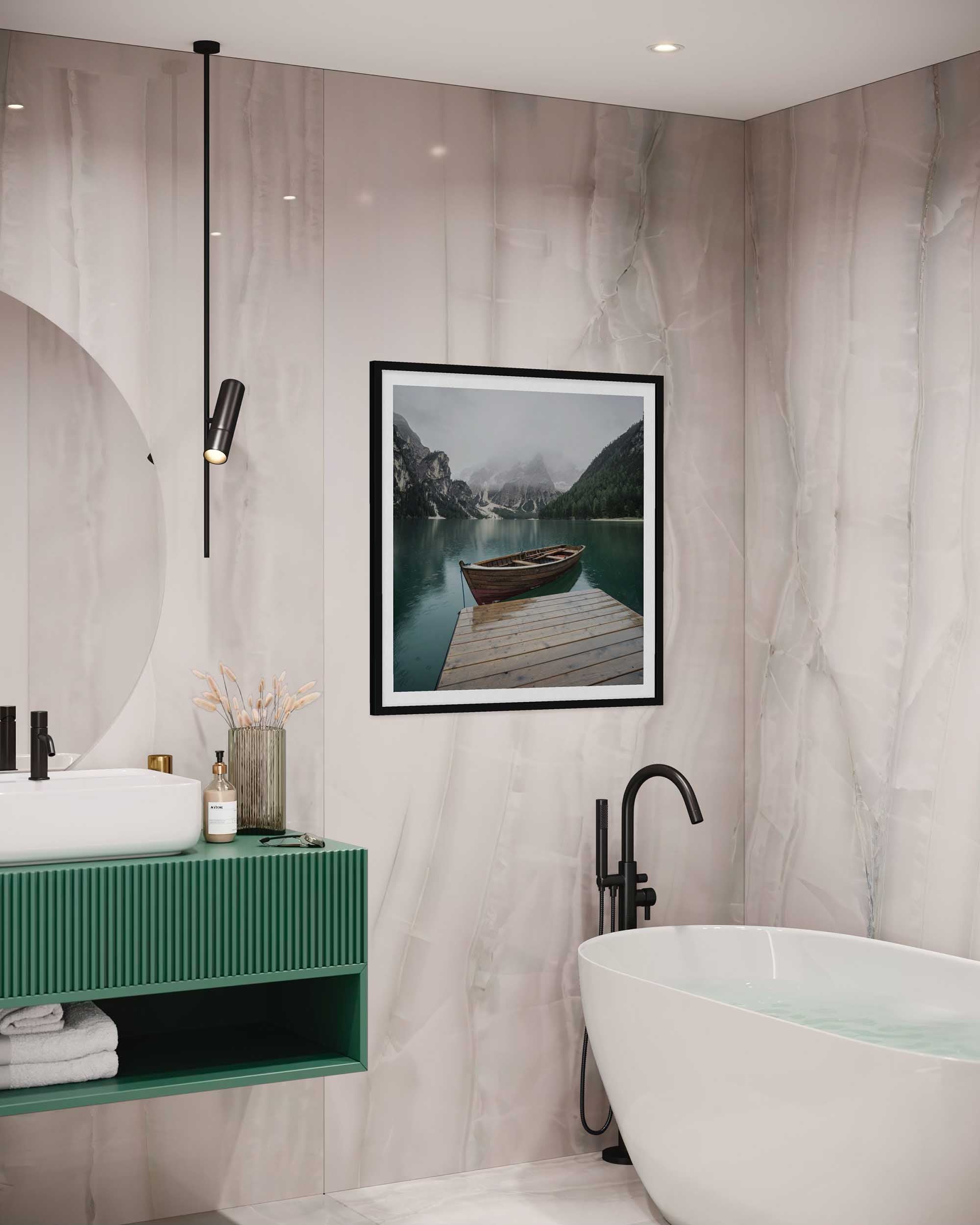 Modern bathroom with green vanity, white bathtub, and framed picture on wall.