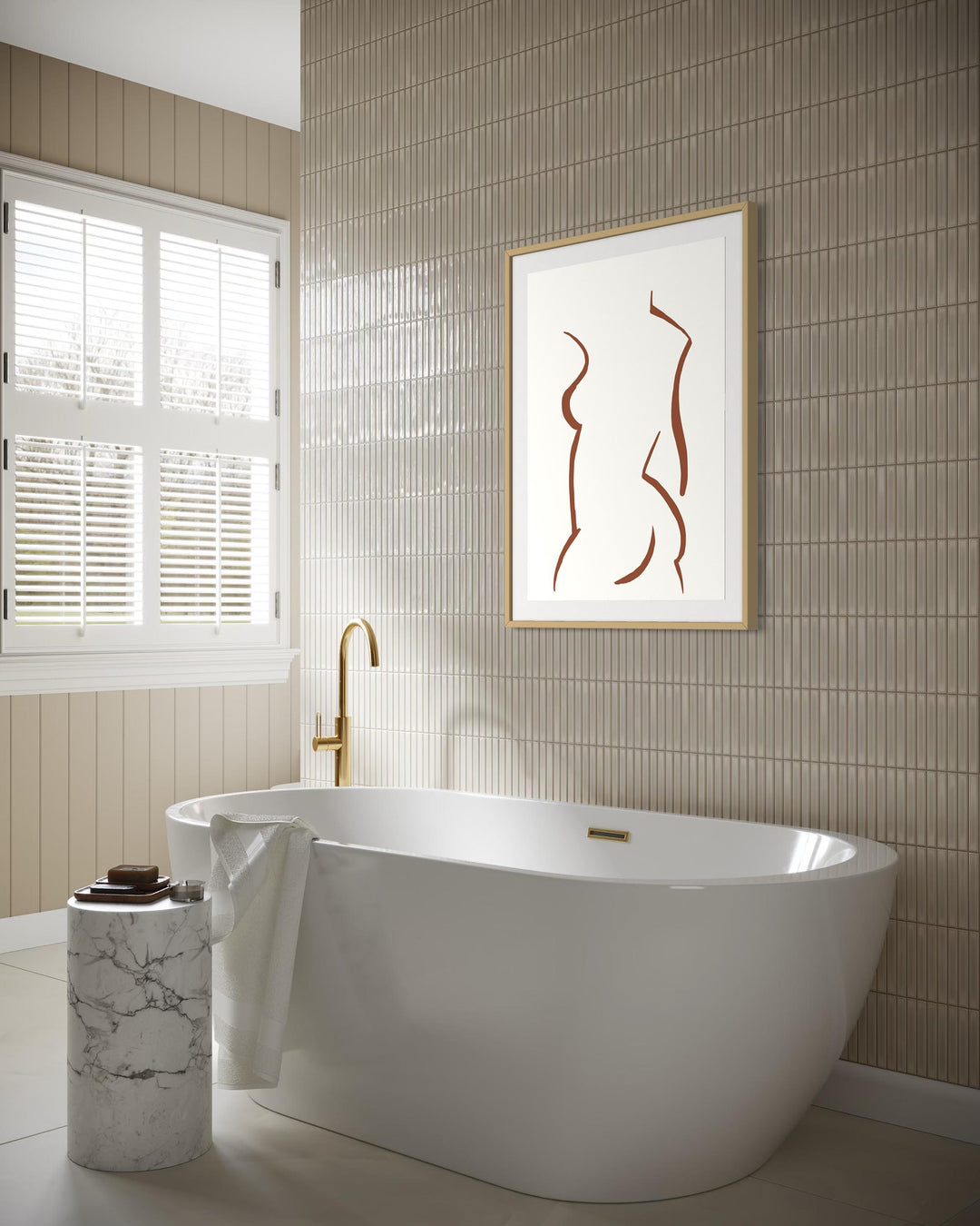 Modern bathroom with a freestanding bathtub, marble candle holder, and abstract art on the wall.