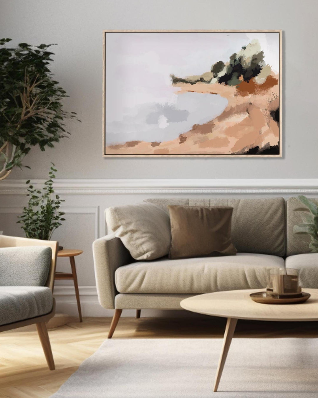 Modern living room with a beige sofa, armchair, and abstract painting on the wall.