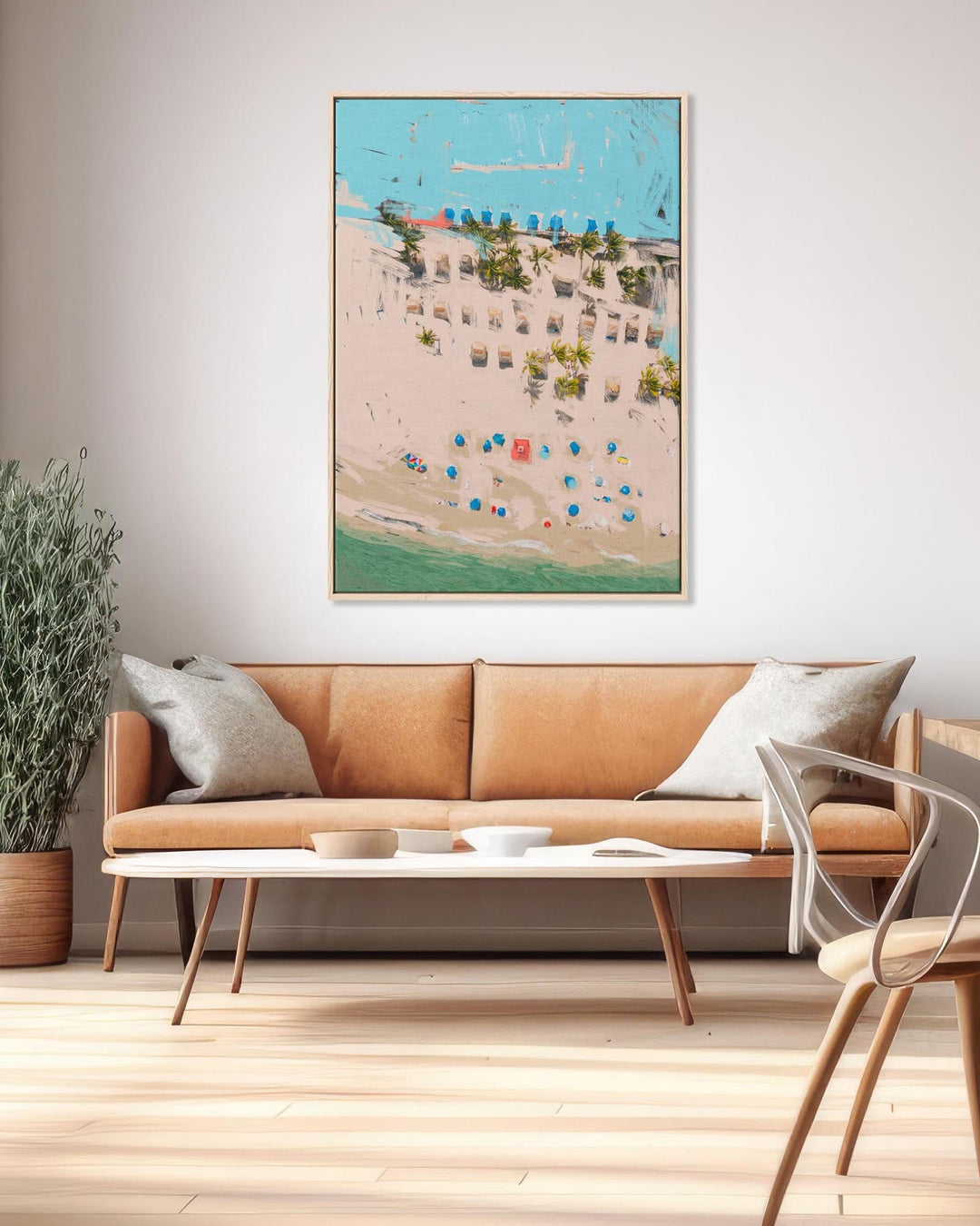 Living room with a brown sofa, coffee table, and decorative wall art.