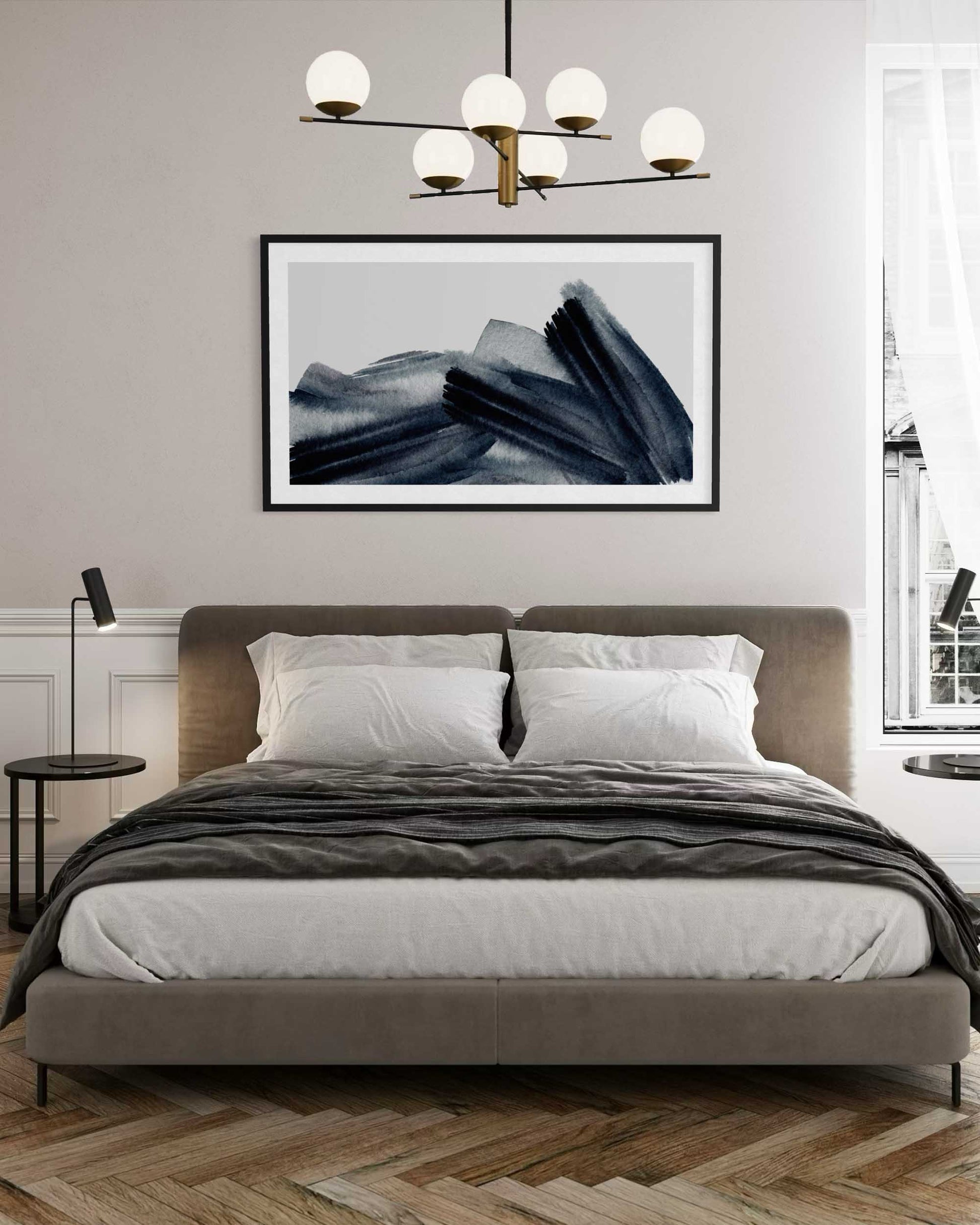 Modern bedroom with a bed, abstract art on the wall, and a chandelier.