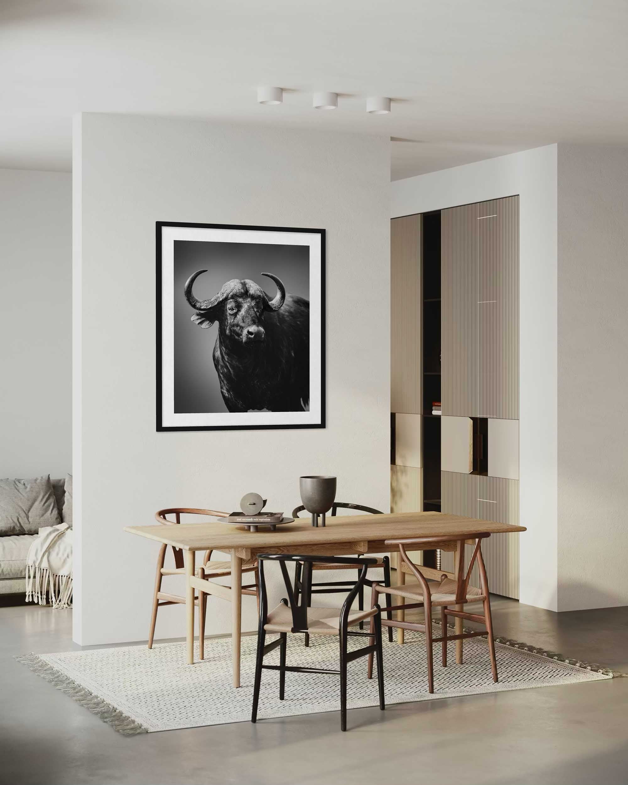Modern dining room with a framed black and white bull artwork on the wall.