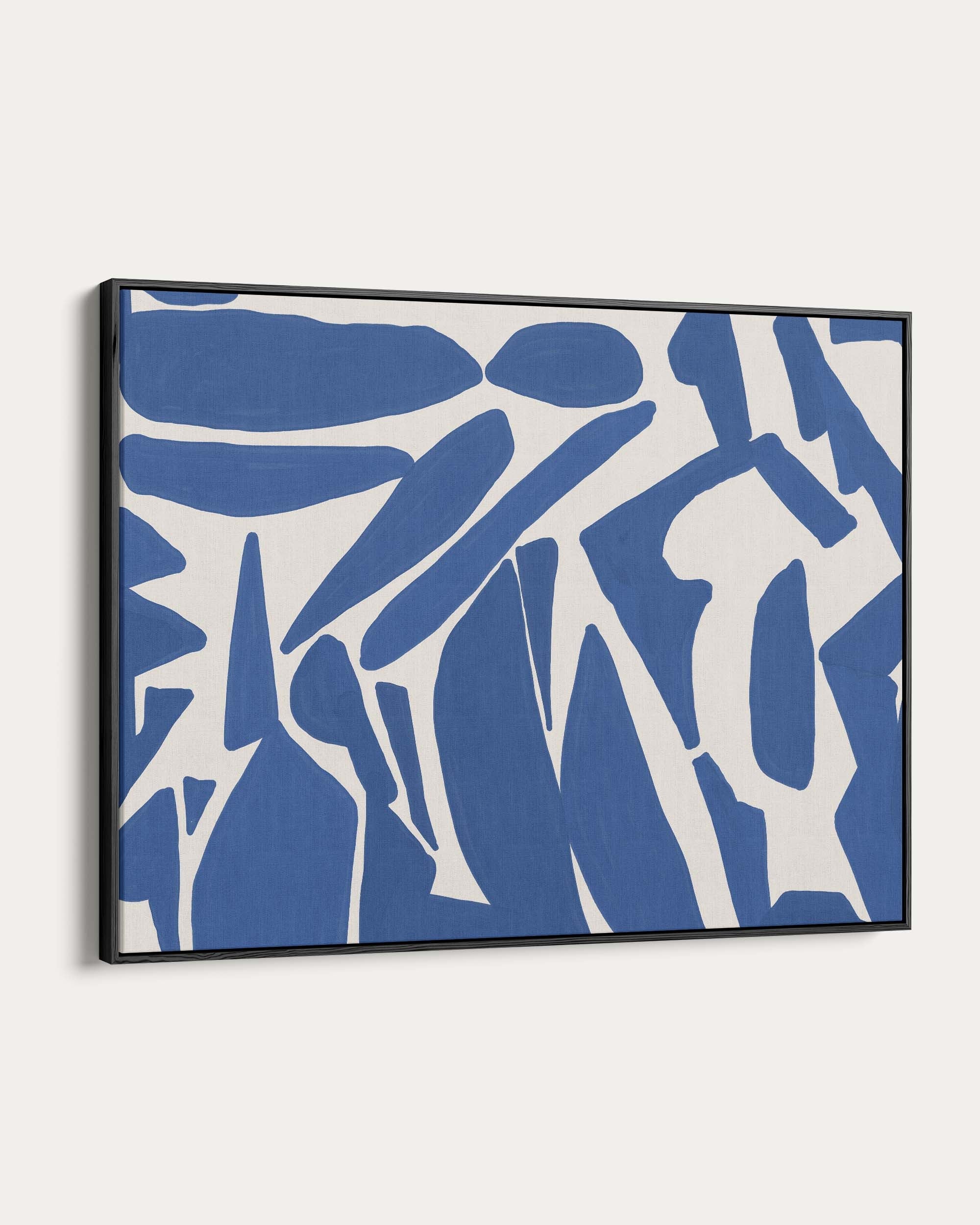 Framed abstract art with blue and white shapes on a white background