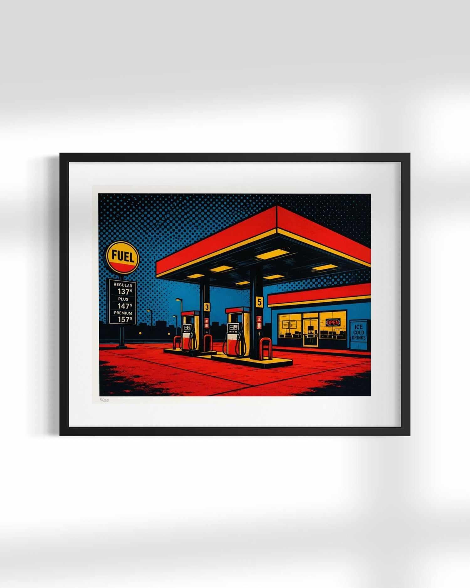 A framed pop art print of a retro gas station, featuring bold red, yellow, and blue colors with halftone patterns, presented in a black frame with a white mat against a light gray background.