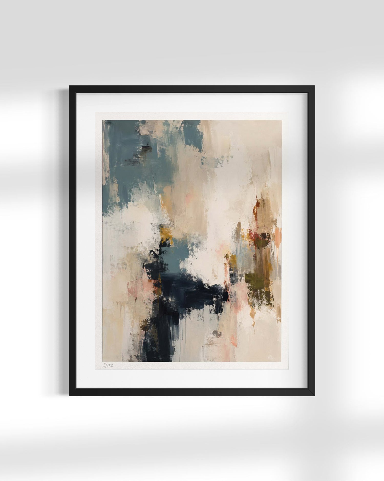 A framed abstract art print featuring textured brushstrokes in beige, slate blue, black, and soft orange, presented in a black frame with a white mat against a light gray wall.