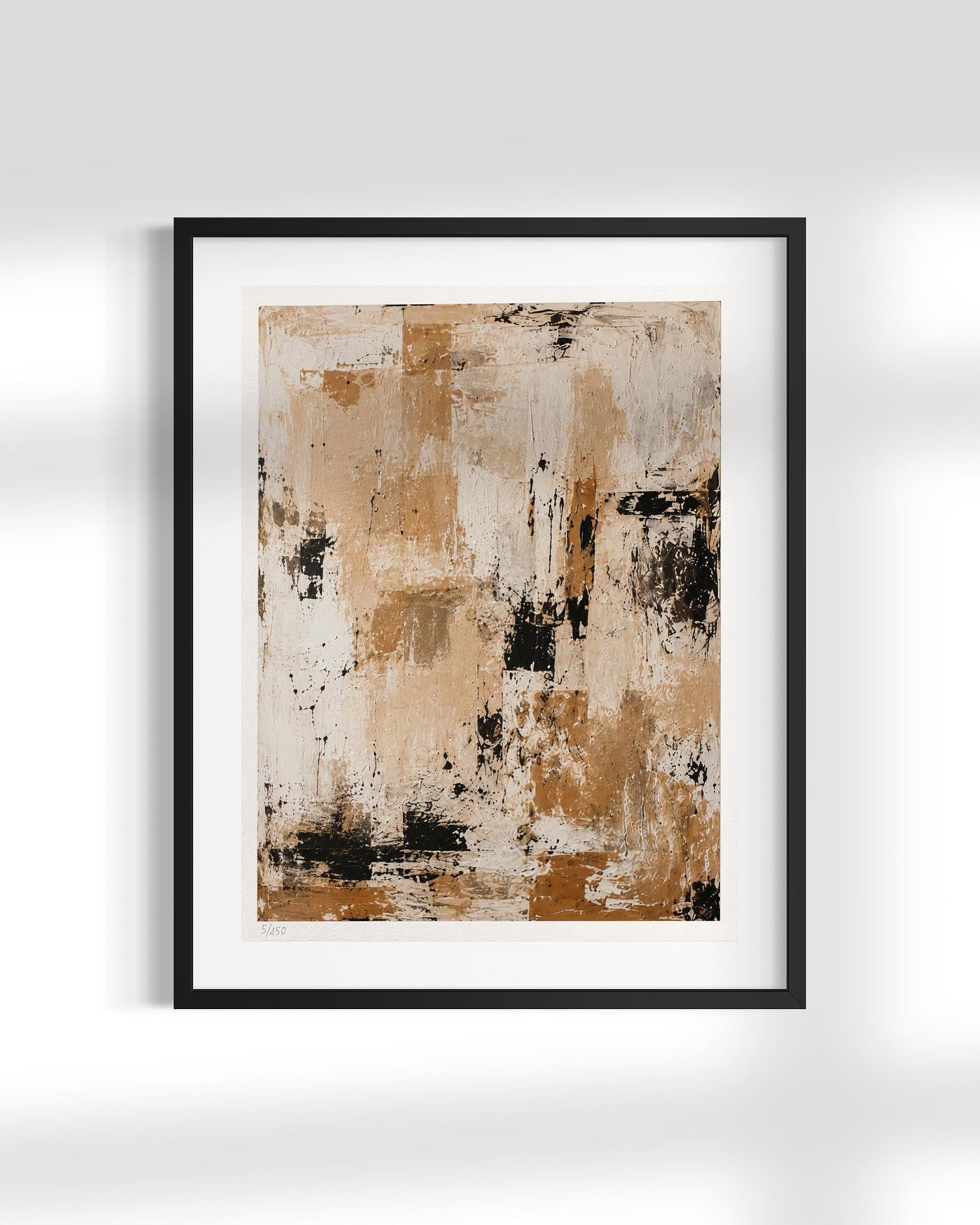 Framed abstract wall art print with a black frame and white mat, featuring textured brushstrokes in beige, brown, cream, and black, displayed against a light gray wall.