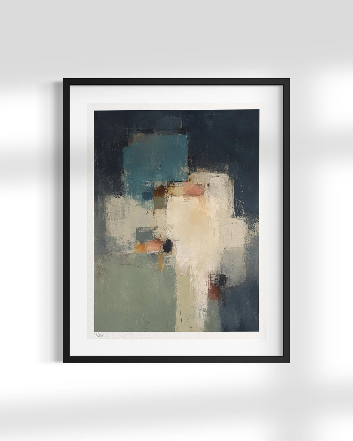 A framed abstract art print featuring a textured composition of navy, teal, cream, and sage green tones, presented in a black frame with a white mat against a light gray wall.