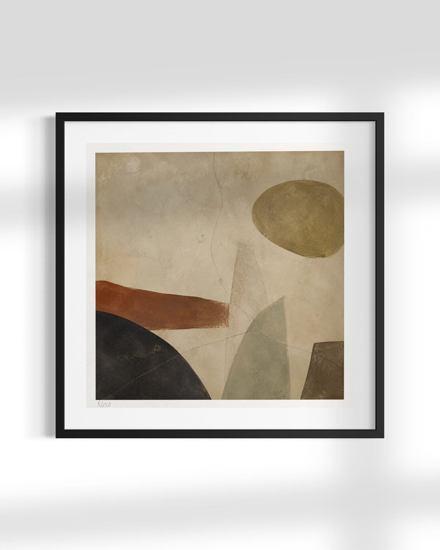 Framed abstract wall art featuring geometric shapes in beige, brown, black, gray, and muted gold, displayed against a light gray wall.